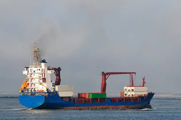 Large container ship entering the port of Rotterdam from the North Sea.