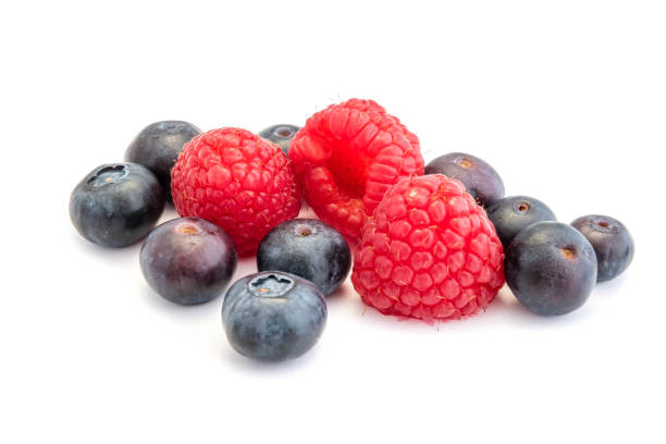 istock Blueberries and raspberries isolated on white background 1212993310