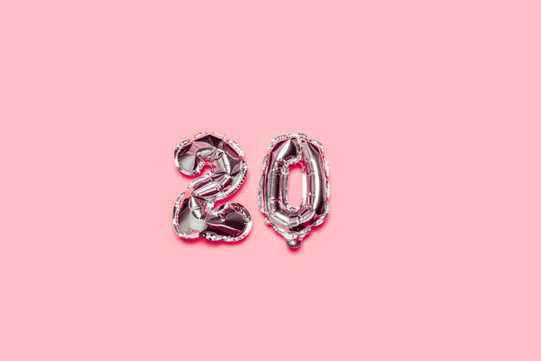 istock Silver foil balloon number 20 on a pink background 1212993324