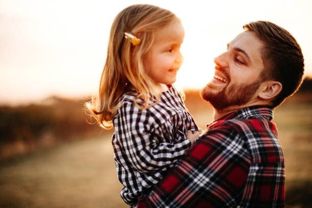 istock Father playing with baby on meadow 1212995013