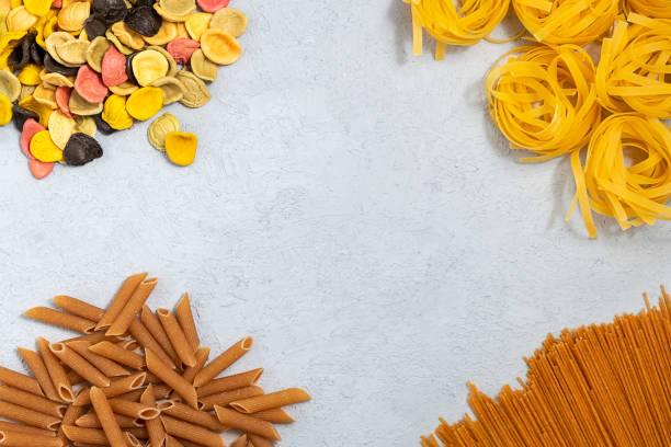 istock Assortment of italian pasta on concrete grey background. Top view with copy space 1212995350