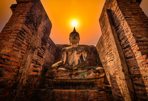 big buddha at sunset in wat mahathat temple, sukhothai historical park, thailand. - thailand asia famous place stone imagens e fotografias de stock