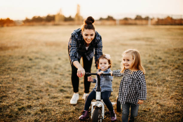 istock Mother playing with kids in meadow 1212996788