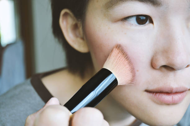istock Woman brushed powder on face, soft focus photo. 1212997037