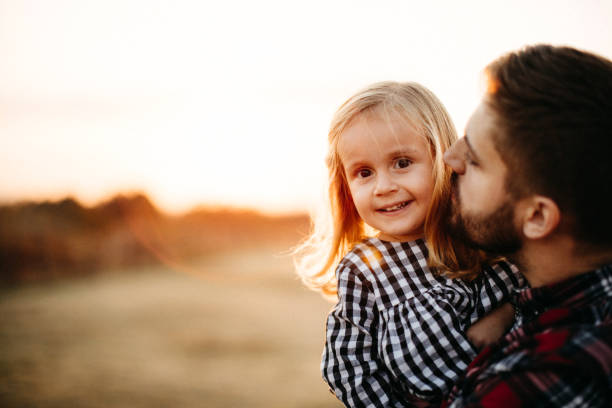 istock Father playing with baby on meadow 1212997598