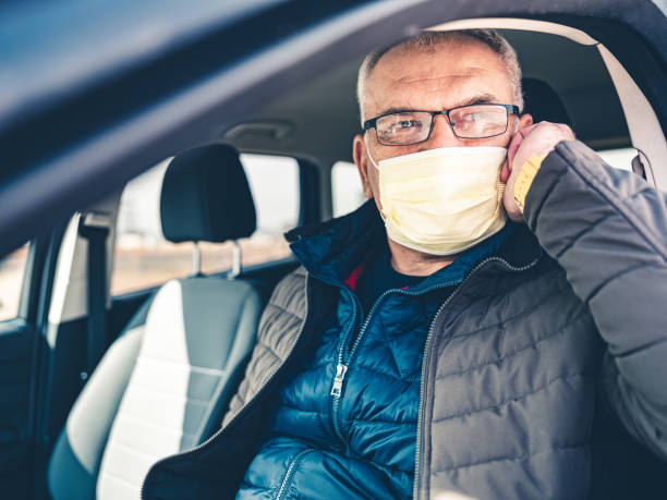 istock COVID-19, Mature man wearing disposable face mask 1212999660