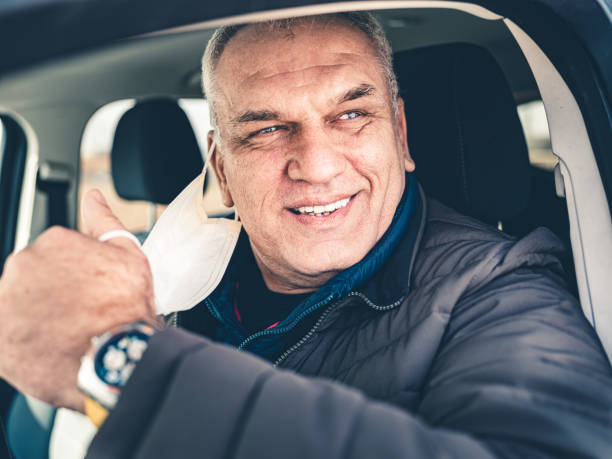 istock COVID-19, Mature man taking off disposable face mask 1213001261