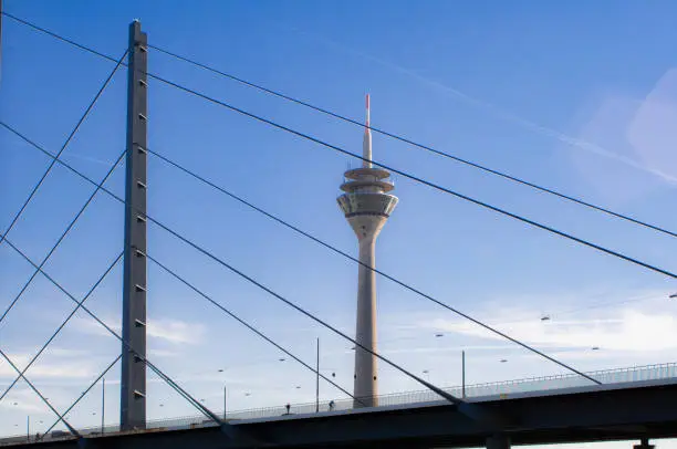 The Düsseldorf TV Tower, one of the city's landmarks. In the foreground excerpts of the well-known Rhine knee bridge.