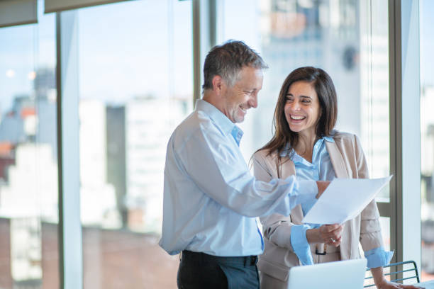 istock Two business workers discuss a project in open plan coworking offices, Buenos Aires 1213003358