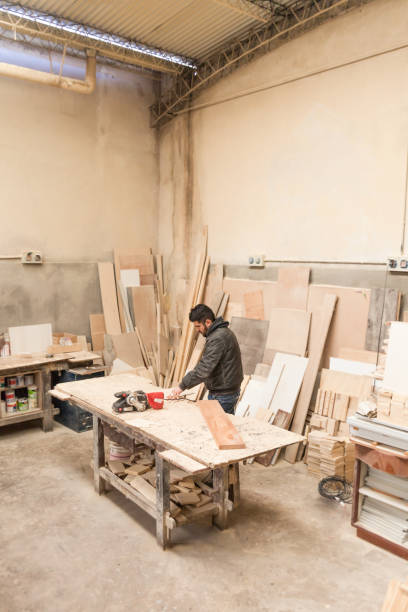 istock Carpenter working with wood in a lumberyard 1213003642