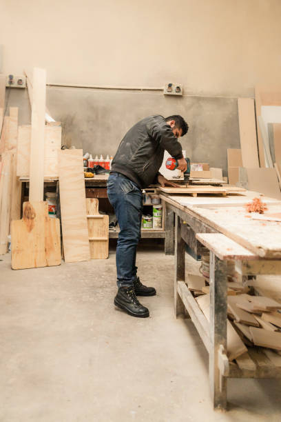 istock Carpenter working with wood in a lumberyard 1213003975