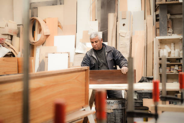 istock Carpenter working with wood in a lumberyard 1213004036