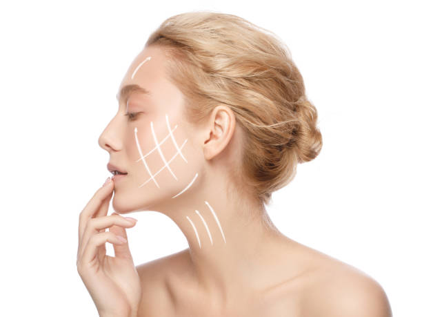 face lift and anti aging concept. side portrait of beautiful woman with perfect clean skin with arrows on face, isolated on white background - rebellion aging process facial mask beauty treatment imagens e fotografias de stock