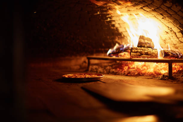 istock Delicious pizza baking in a wood fire oven 1213008337