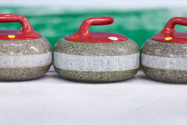 istock Sport Concepts. Closeup of Curling Blue Handle Stones on Ice.With Copyspace. Horizontal Image 1213008590