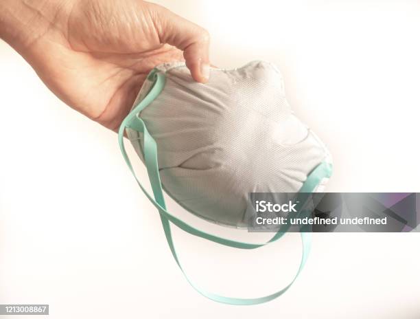 Person Hand Holds A Fpp3 Mask Isolated On White Stock Photo - Download Image Now - Adult, COVID-19, Care