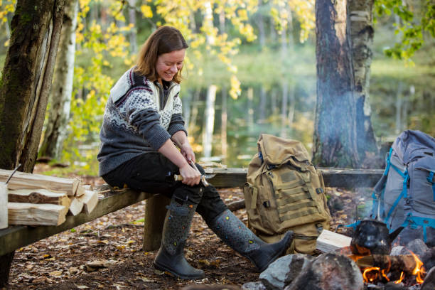 istock Man and woman roasting on campfire in forest 1213009069