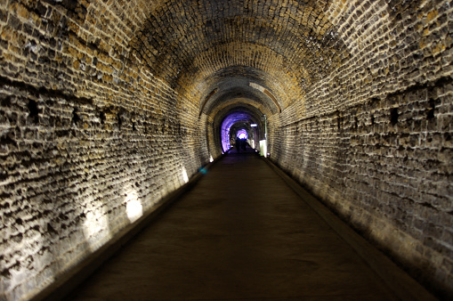 brick train tunnel with white lights