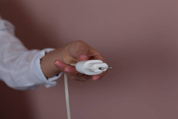 istock woman hand holding phone charger 1213012002