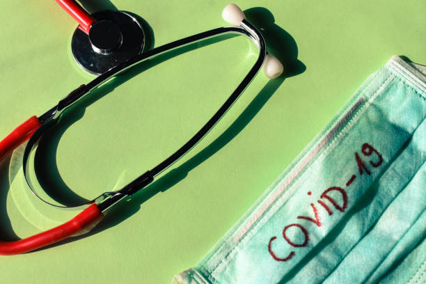 istock Red stethiscope and a face mask with covid 19 letters 1213012276