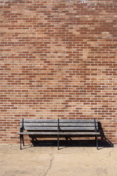 istock Wooden bench and brick wall 1213013704