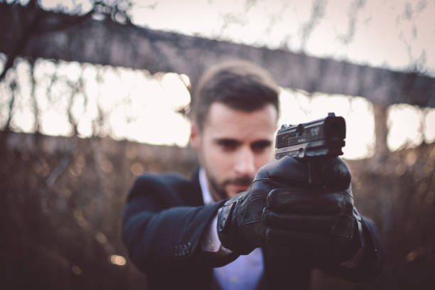 istock Sexy man holding gun 1213016465
