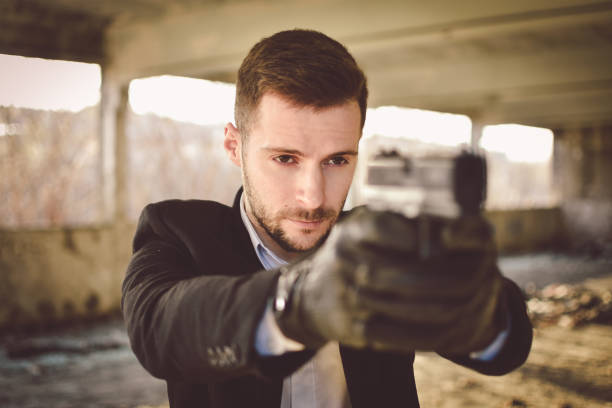 istock Sexy man holding gun 1213016559