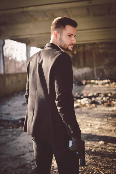 istock Sexy man holding gun 1213017269