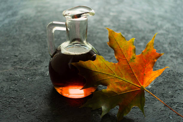 maple syrup and maple leaf on a black background. - tree isolated maple tree green imagens e fotografias de stock