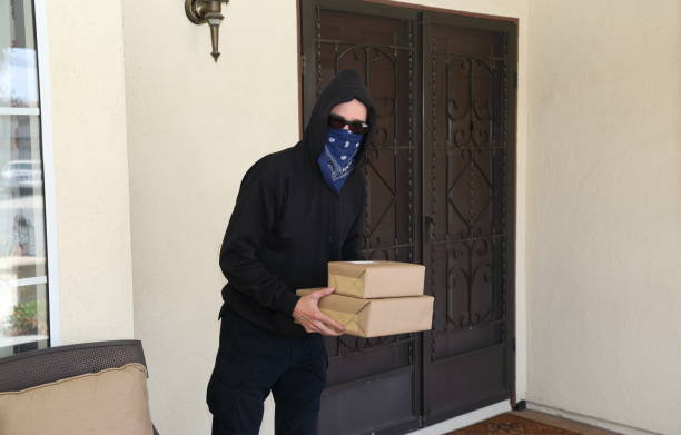 istock Porch Pirate Steals Packages Mask Horizontal 1213021591
