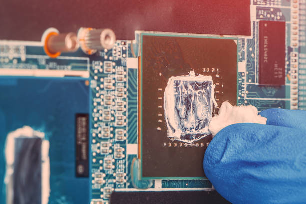 istock Application of thermal paste on the laptop processor chip for high-quality cooling. 1213021597