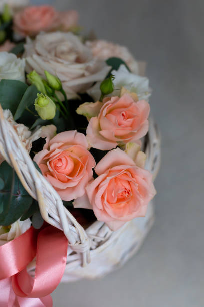istock Pastel trend colored flowers in white basket isolated, selective focus 1213023573