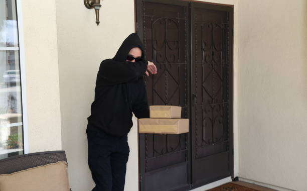 istock Porch Pirate Steals Packages Hides Face WS 1213024124