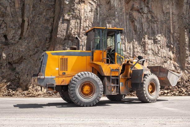 istock Heavy yellow tractor clears a mountain road 1213025097