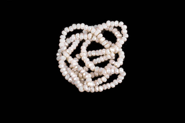 istock Natural stone beads on a black background isolated 1213027360