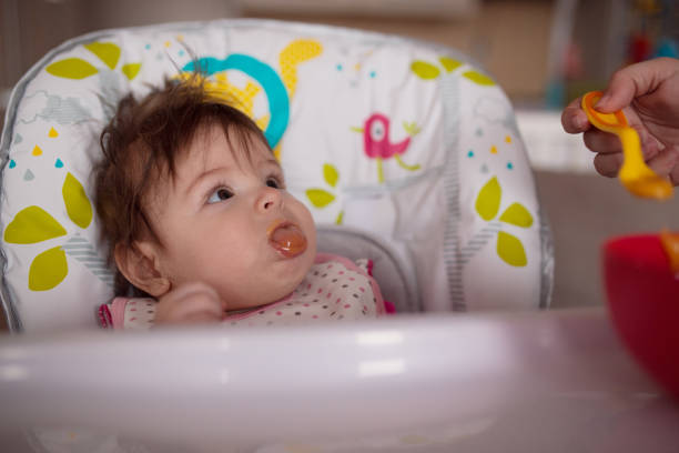 istock Mother feeding her baby daughter 1213029451