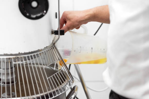 istock Close up of Pastry chef Adding Ingredient To Batter Machine at confectionery. 1213029518