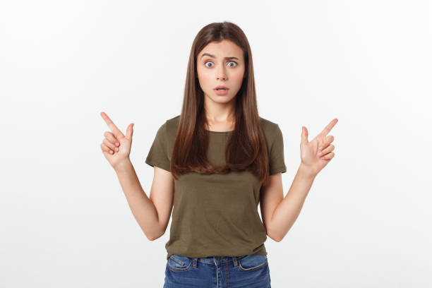 istock Portrait happy and surprised young lady standing isolated over grey background. Looking camera pointing. 1213029606