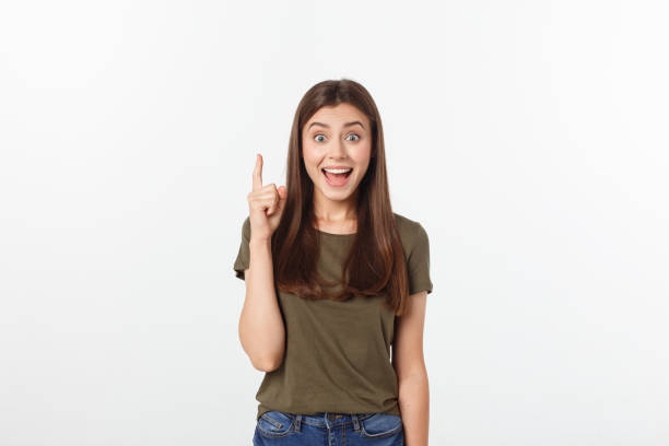 istock Portrait happy and surprised young lady standing isolated over grey background. Looking camera pointing. 1213029867
