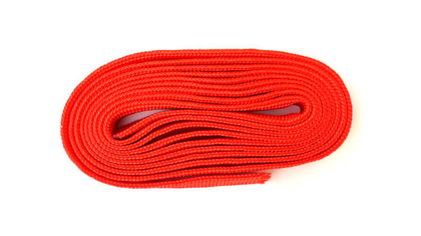 istock Fabric rope in red color folded in a coil. Red rope on white background. 1213030866