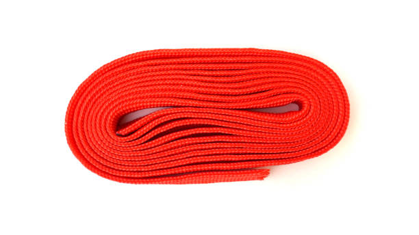 istock Fabric rope in red color folded in a coil. Red rope on white background. 1213030886