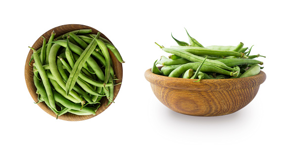 Fresh green vegetables isolated on a white background. Green bean in wooden bowl. Vegetables with copy space for text. Haricot beanisolated on a white. Top view.