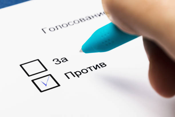 istock On the sheet there is an inscription in Russian: Pros and Cons. Voting concept 1213031476