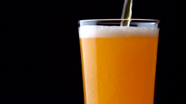Cold light beer poured into a glass