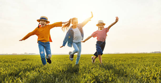 istock Happy children running in field 1213037318