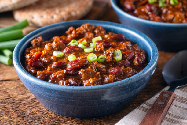 Beef Chili Delicious homemade beef chili con carne with green onion garnish. chili con carne photos stock pictures, royalty-free photos & images