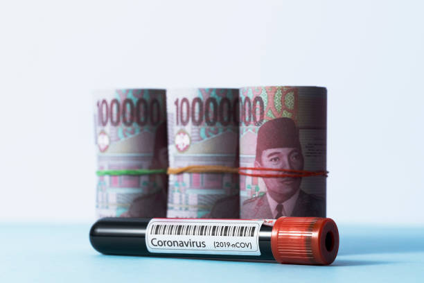 Coronavirus test tube and Indonesian rupiah Coronavirus test tube and money bundle, Indonesian rupiah. Blood sample in vacutainer, blood collection tube with 2019-nCOV label. bloody money stock pictures, royalty-free photos & images