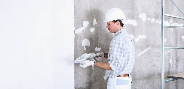 istock plasterer man at work with trowel plastering the wall of interior construction site wear helmet and protective gloves, scaffolding on background and copy space on white wall 1213044900