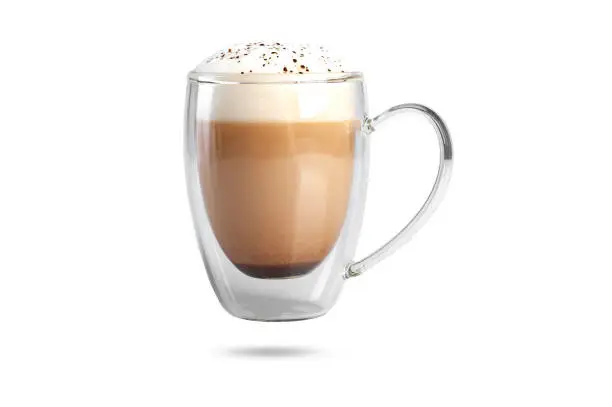 cappuccino with cinnamon on a foam in a transparent cup with a double bottom. isolate on white background.