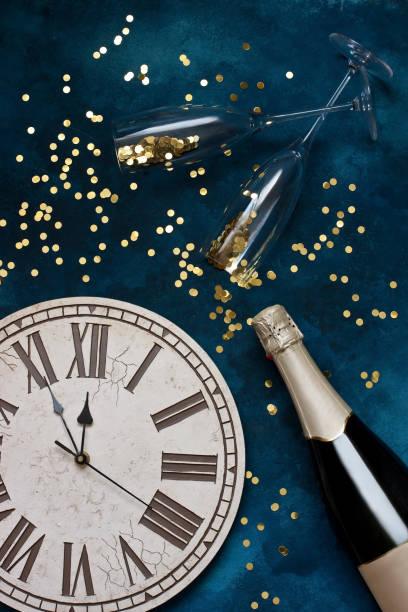 istock Champagne bottle and glasses  with Christmas  clock. Flat lay 1213046661